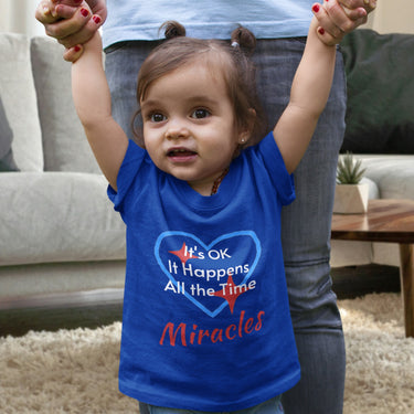 Bella+Canvas baby t-shirt with “Miracles Happen” design and uplifting message, soft cotton, breathable and durable, Christian apparel for infants and family matching, baby girl in blue shirt